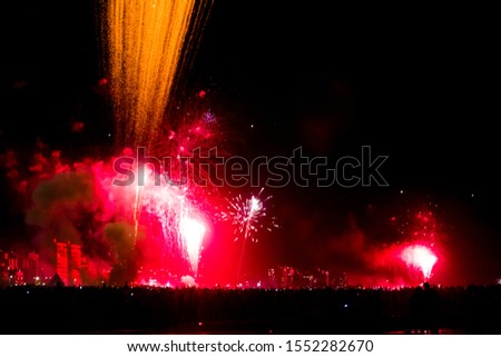 

Colorful fireworks at night with people silhouette.