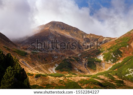 Rodna Mountains  -  Mt Ineu, view from the mountain trail starting from the Rotunda Pass towards Mt. Ineut, Mt. Ineu, Lala Mare Lake and Lala Mica Lake. Eastern Carpathians, Romania,  autumn time. Royalty-Free Stock Photo #1552284227