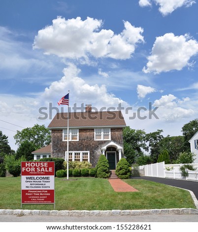 Real Estate Welcome Open House For Sale Sign Affordable No Closing Costs on Front yard lawn of Gable Style Suburban Home American Flag Waving Blue Sky Clouds USA