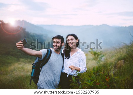 Happiness man and woman taking a phone selfie together at outdoor,Couple in love,Happy and smiling