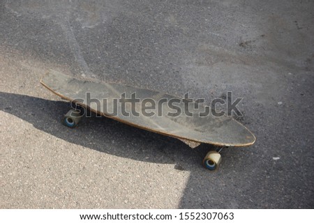 A black skateboard outside rollin 