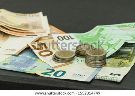 Coins and bills of different values in bird perspective