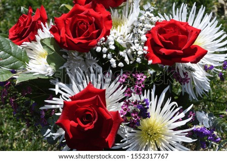 bouquet of bright red roses and other flowers