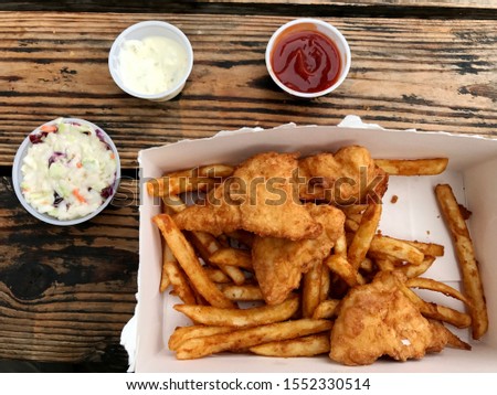 Picture of fish and chips with coleslaw salad.
