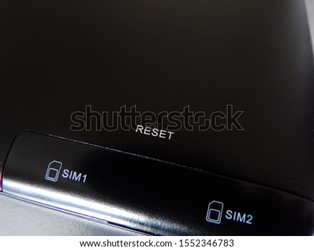 Tablet computer close-up. Slots for two SIM cards. Reset button. A device for working with clients.