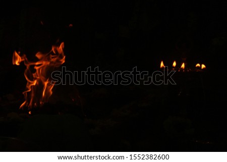 uncontrollable Fire and oil lamp fire flames on one single picture with orange / red / black and white color fire flame with black background.