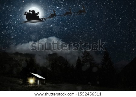 silhouette of a flying goth santa claus against the background of the night sky. Elements of this image furnished by NASA