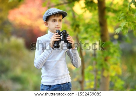 Boy exploring looking through binoculars