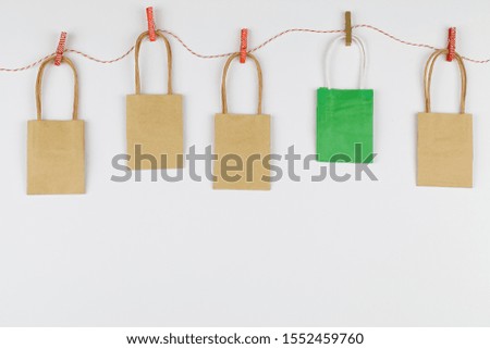 colored packaging bags suspended on clothespins on white background. Top view Flat lay . sesonal sale, retail, shopping concept