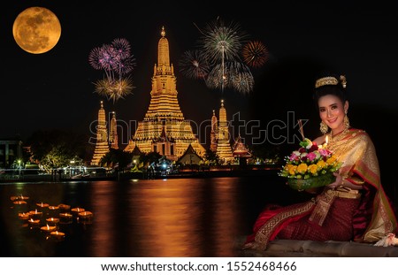 Asia young woman in Thai dress traditional hold kratong, Loy Krathong Day.Loy Kratong Festival Royalty-Free Stock Photo #1552468466