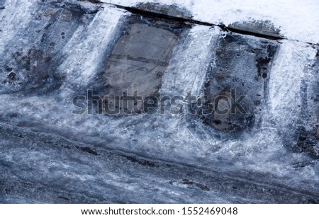 Parking place with traces of the car body after snowfall, top view in winter