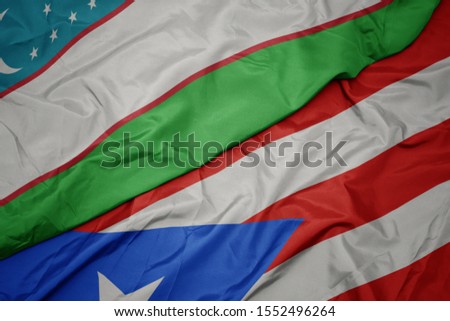 waving colorful flag of puerto rico and national flag of uzbekistan. macro
