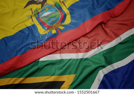 waving colorful flag of south africa and national flag of ecuador. macro
