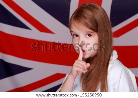 Portrait of a young girl's sweet smile is on the background of the flag the UK
