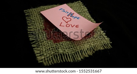 faith hope love concept displaying with using text slips on black background 