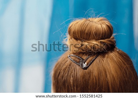 hair bundle is a hairstyle for girls for rhythmic gymnastics on blue background