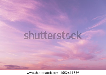 Dramatic sunrise, sunset pink violet sky with clouds background texture Royalty-Free Stock Photo #1552611869