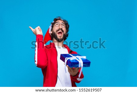 young crazy bearded man with santa hat. Christmas concept