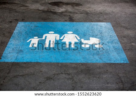 Sign on the pavement, parking space for a large family