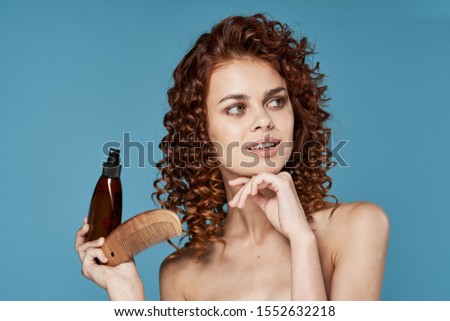 Beautiful woman model jar with lotion blue curly hair background