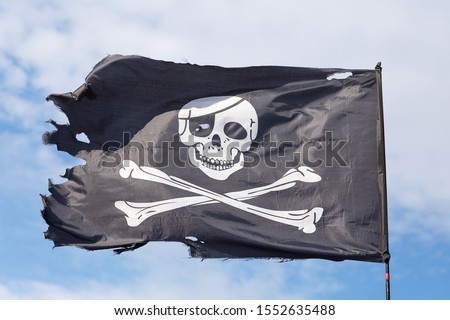 Symbol of the pirates Jolly Roger against the sky.