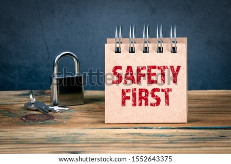 Safety First. Workplace, home, social media and child safety concept. Padlock and notebook on table