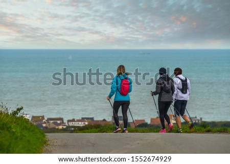 group of hikers in Nordic walking on the coast in northern France