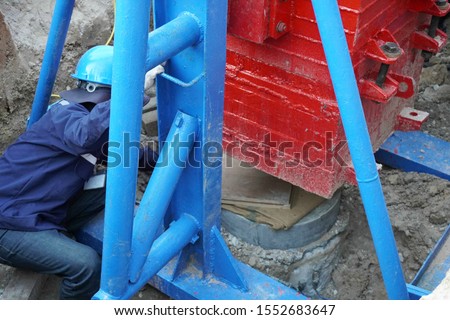 Engineers are testing load resistance of pile by Dynamic pile load test methods. Royalty-Free Stock Photo #1552683647