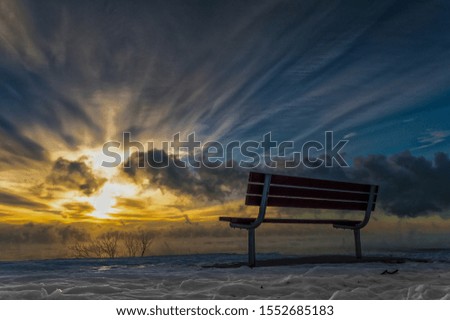 A park bench faces the morning sunrise in a place people come to reflect and talk