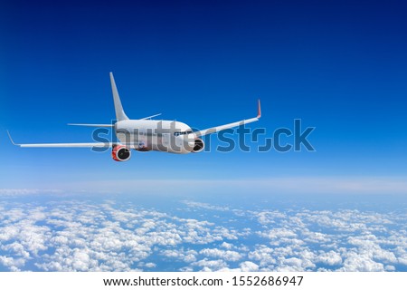 White airplane flying above cloud Royalty-Free Stock Photo #1552686947