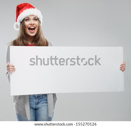 Christmas woman hold big white card. Santa hat. Isolated smiling girl.