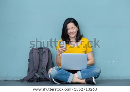 hand holding using texting cell phone and typing computer.woman at workplace Thinking investment plan.chatting contact Investor.searching for information use internet.connecting people concept