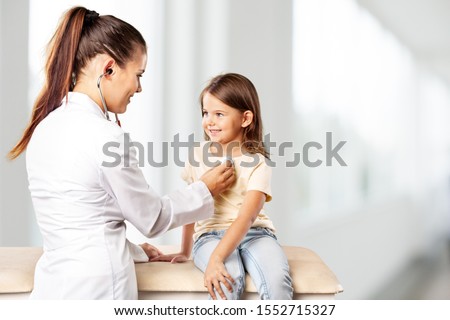 Male pediatrician hold stethoscope exam child boy patient visit doctor with mother, black paediatrician check heart lungs of kid do pediatric Royalty-Free Stock Photo #1552715327