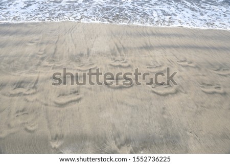 Abstract texture of sand and traces from rolling wave