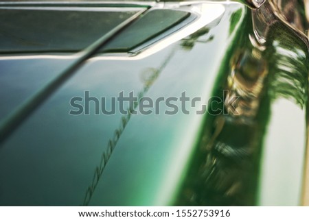 green car wing on a classic american car manufacturer