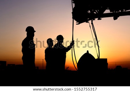 Silhouette of riggers working with mobile crane in the oilfield at sunset
 Royalty-Free Stock Photo #1552755317