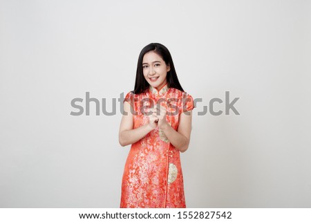 Happy chinese new year Beautiful Asian woman wearing red Chinese traditional dress in classic vintage style smiling, on gray banner background with copy space for concept