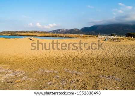 Beautiful wild beach with clear turquoise water and rocks. Malia, Crete island, Greece.