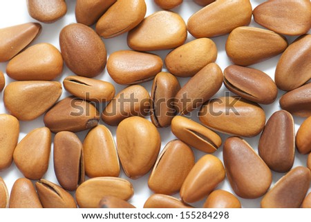 Some pine nuts on white background, very close