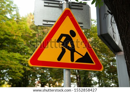 Road sign of reconstruction in the city. Attention. Construction work in progress.