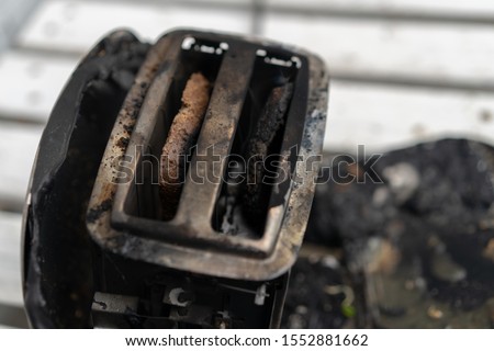 Burning toaster. Toaster with two slices of toast caught on fire over white background. Danger of careless handling of electrical appliances. Fire Royalty-Free Stock Photo #1552881662