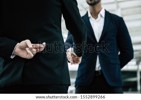 Businessman or politician cross finger, hiding behind his back during he get handshake to another person, businessman. Businessman pretend to be good person, he is liar. White collar worker is fraud