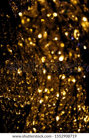 Golden shiny luxury blurred glass sparkling background. Festive concept for your design.