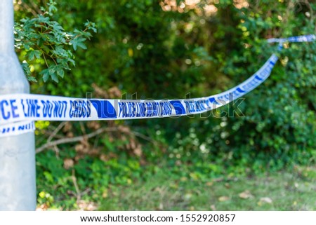 Crime scene -  surrounded by blue police tape,  