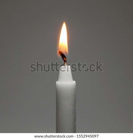 white candle light on the gray background