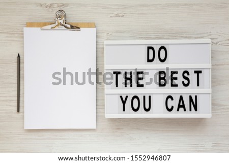'Do the best you can' words on a modern board, clipboard with blank sheet of paper on a white wooden background, top view. Overhead, from above, flat lay. 