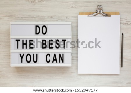 'Do the best you can' words on a modern board, clipboard with blank sheet of paper on a white wooden surface, top view. Overhead, from above, flat lay. 