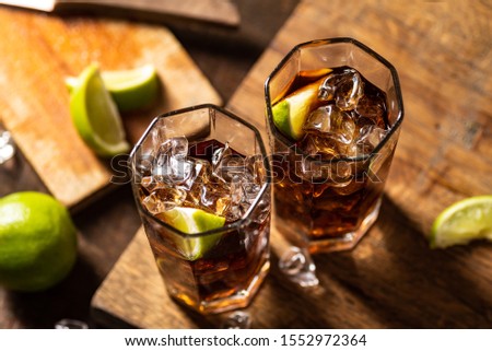 Cuba libre drink on wooden table
