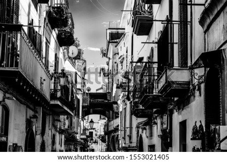 Picturesque narrow alley in world famous old town Amalfi, Italy. Black and white effect