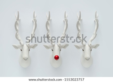 Christmas reindeer decoration with red Christmas bauble. Creative minimal funny holiday concept.
